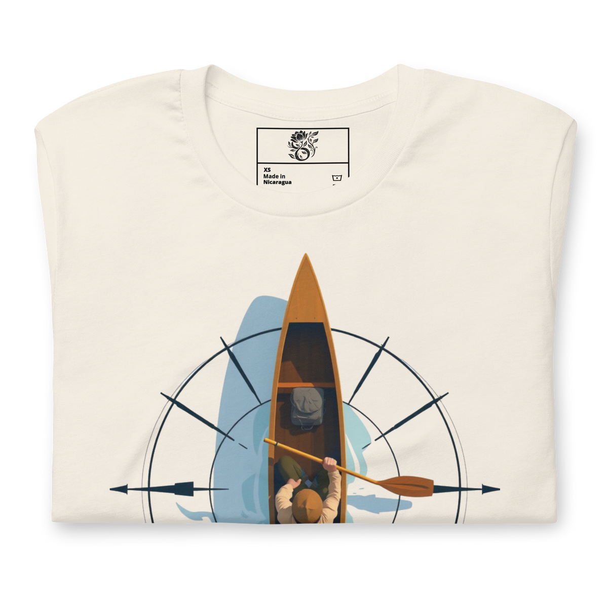 An off-white crewneck t-shirt with a graphic print of a person rowing a canoe on water, viewed from above. The shirt is displayed flat against a solid white background, with the inner neck label showing the brand 'The Watercolor Society'.