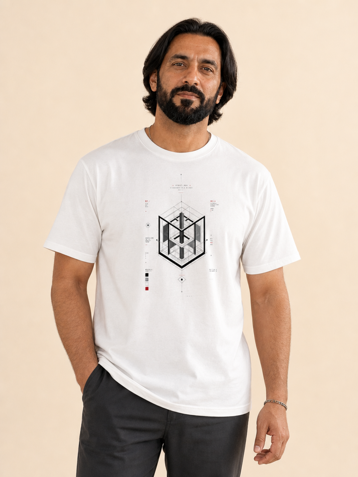 A male model wearing a white crew neck t-shirt featuring a centered black-and-grey geometric architectural blueprint graphic, paired with white trousers against a neutral background.