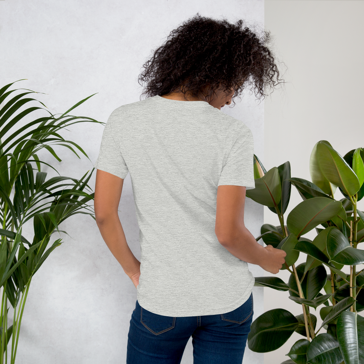 Front view of an athletic heather grey streetwear t-shirt featuring a striking geometric tribal mask graphic in terracotta, cream, and black.