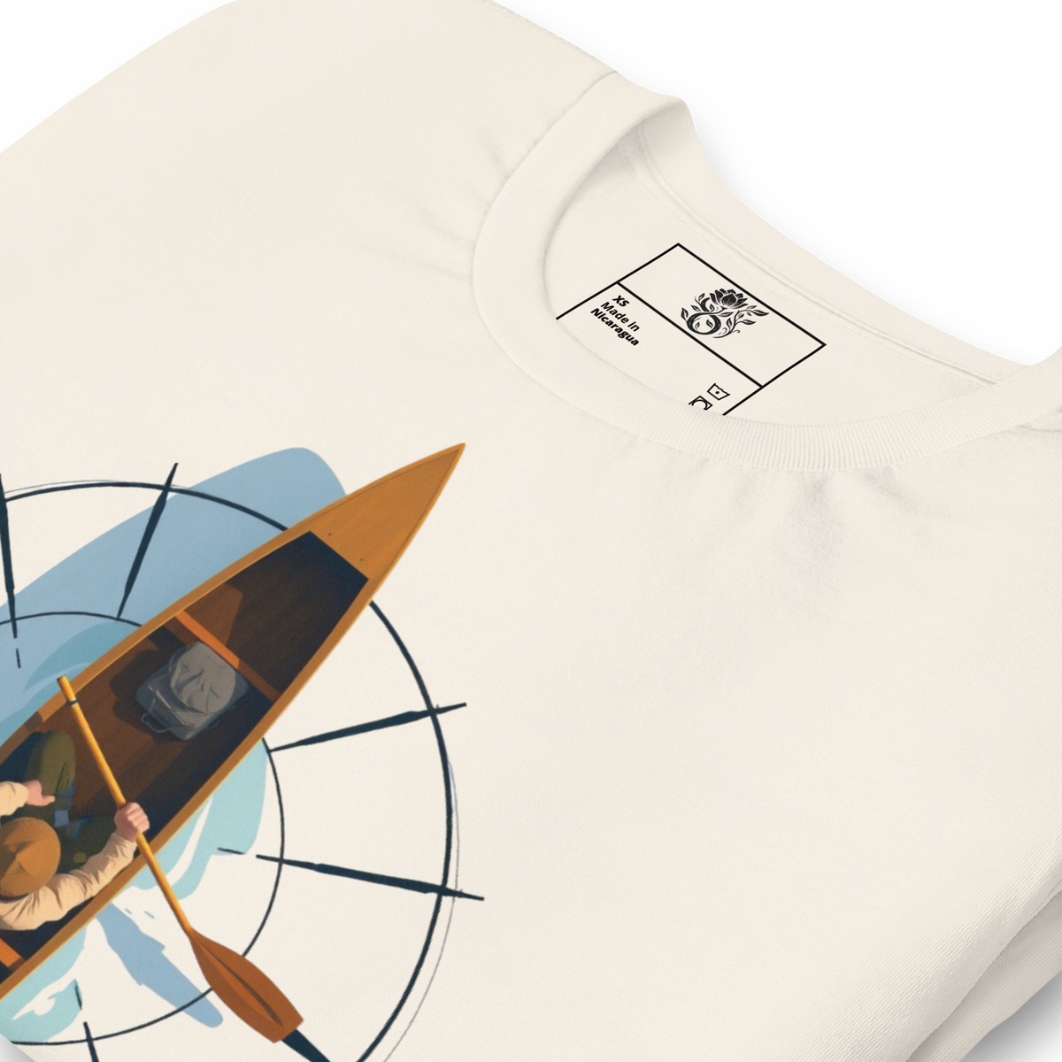 An off-white crewneck t-shirt featuring a graphic print of a person paddling a canoe on blue water, with a black compass design. The inner neck label shows the brand 'The Art of Swimming'.