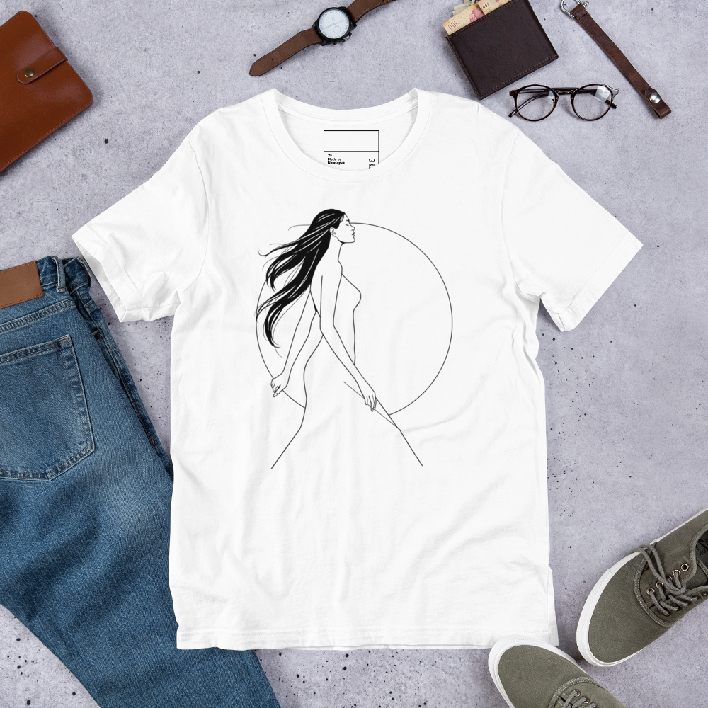 A white short-sleeve t-shirt laid flat on a gray surface, featuring a minimalist black line art graphic of a woman walking inside a large circle. The shirt is styled in a flat-lay arrangement with blue jeans, a brown leather wallet, a watch, eyeglasses, and green sneakers.